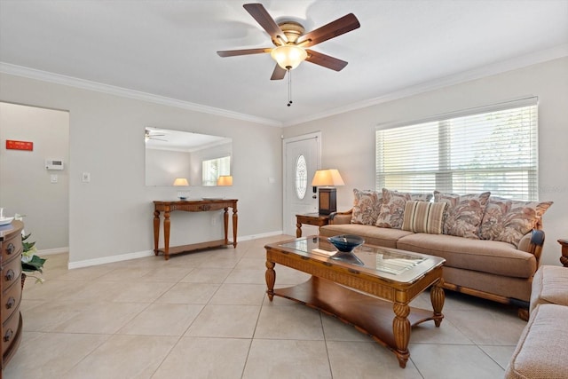 living area with ornamental molding, light tile patterned flooring, a ceiling fan, and baseboards