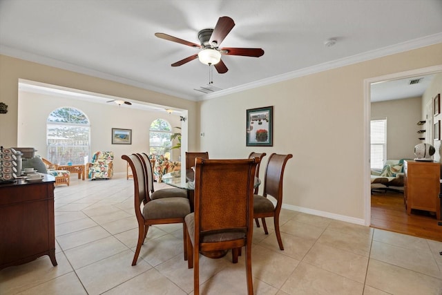 dining area with light tile patterned flooring and crown molding