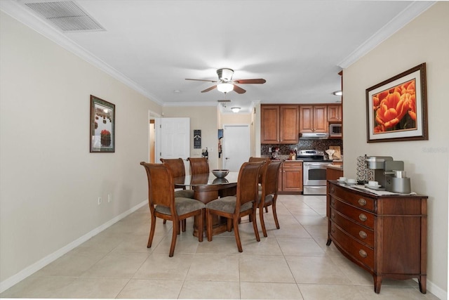 dining area with a ceiling fan, visible vents, crown molding, and light tile patterned floors