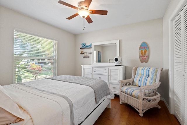 bedroom featuring a ceiling fan, a closet, and dark wood finished floors