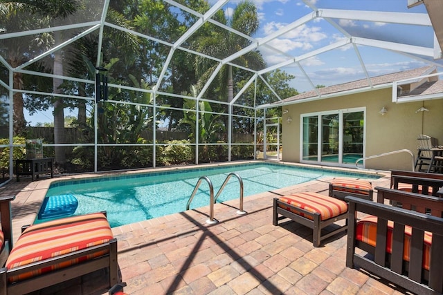 outdoor pool with a patio area, glass enclosure, a hot tub, and a fenced backyard