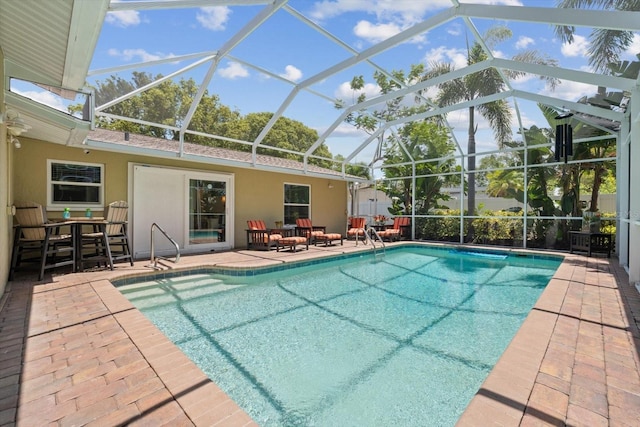 pool with a lanai and a patio