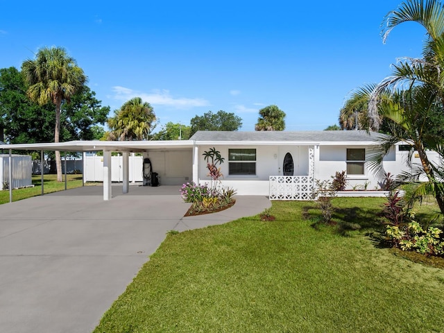 ranch-style house with a front yard and a carport