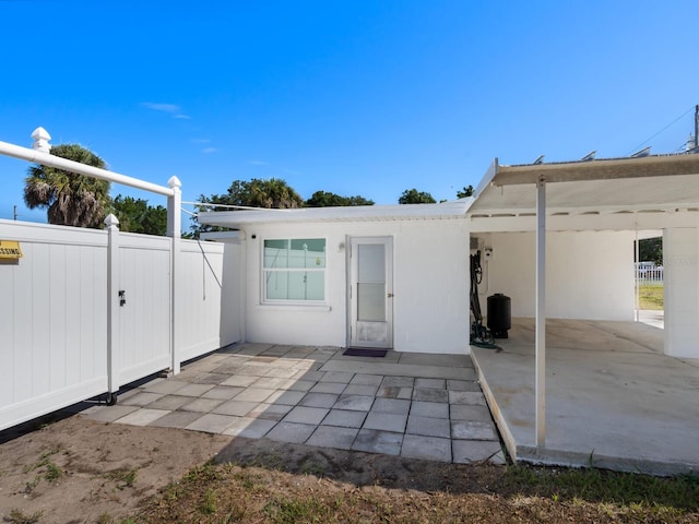 back of property with a patio and a carport