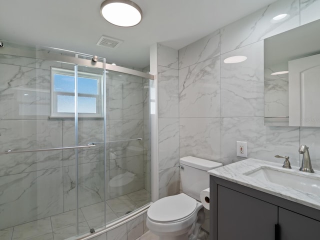 bathroom featuring toilet, vanity, tile walls, and walk in shower