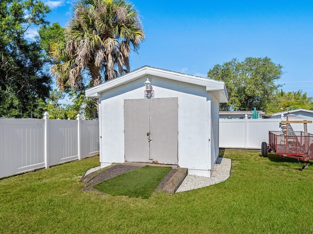 view of outdoor structure with a lawn