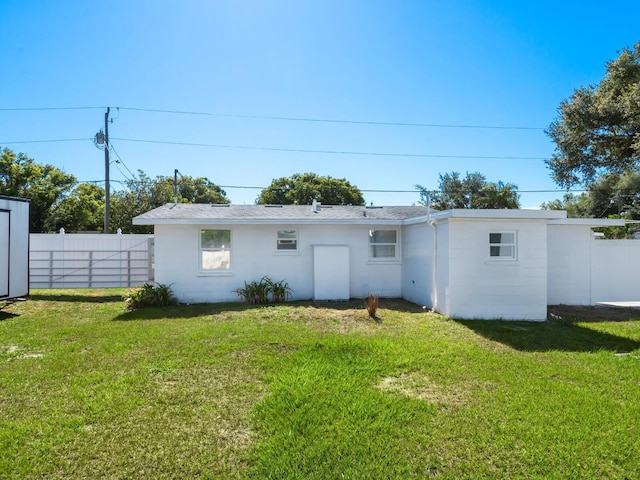 rear view of house with a lawn