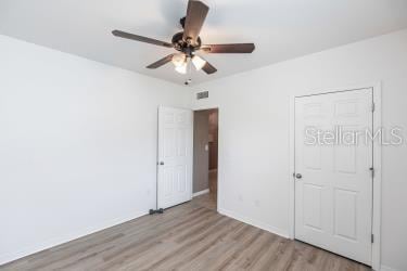 unfurnished bedroom featuring light hardwood / wood-style floors and ceiling fan