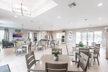 dining area with light tile patterned flooring and a chandelier