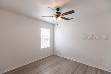 empty room featuring wood-type flooring and ceiling fan