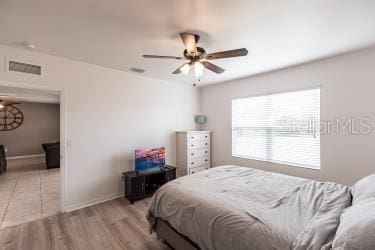 tiled bedroom with ceiling fan