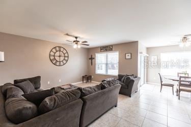 tiled living room featuring ceiling fan