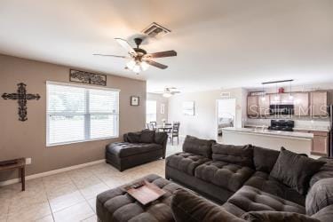 living room with light tile patterned floors and ceiling fan