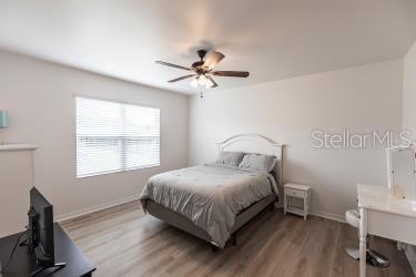 bedroom featuring ceiling fan and hardwood / wood-style flooring