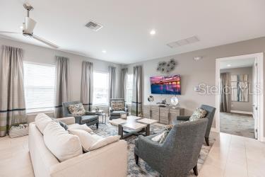 living area featuring visible vents, recessed lighting, and light tile patterned floors