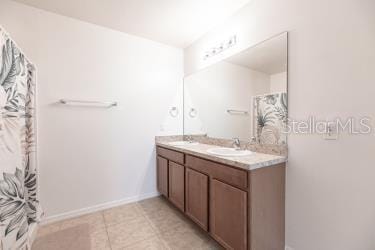 bathroom with tile patterned flooring and vanity