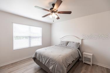 bedroom featuring wood-type flooring and ceiling fan