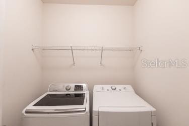 clothes washing area featuring independent washer and dryer