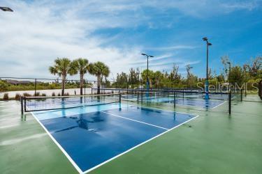 view of tennis court featuring fence
