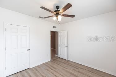 unfurnished bedroom with ceiling fan and light hardwood / wood-style flooring