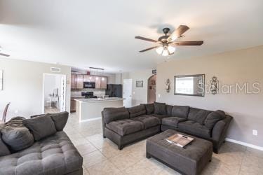 living room with light tile patterned floors and ceiling fan