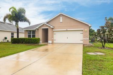 ranch-style house with a garage and a front yard