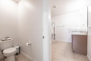 bathroom with tile patterned floors, vanity, and toilet