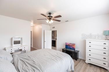 bedroom featuring light wood finished floors and a ceiling fan