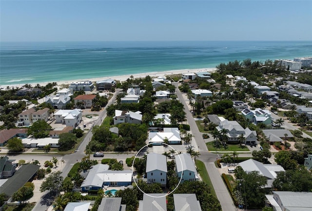 birds eye view of property with a water view and a view of the beach