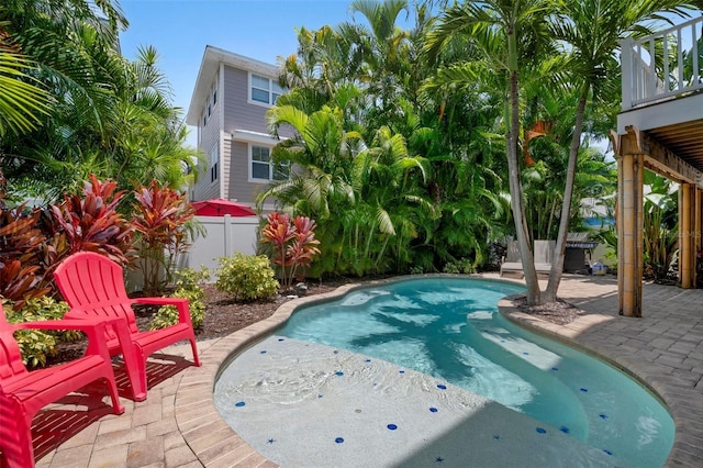 view of pool with a patio and fence