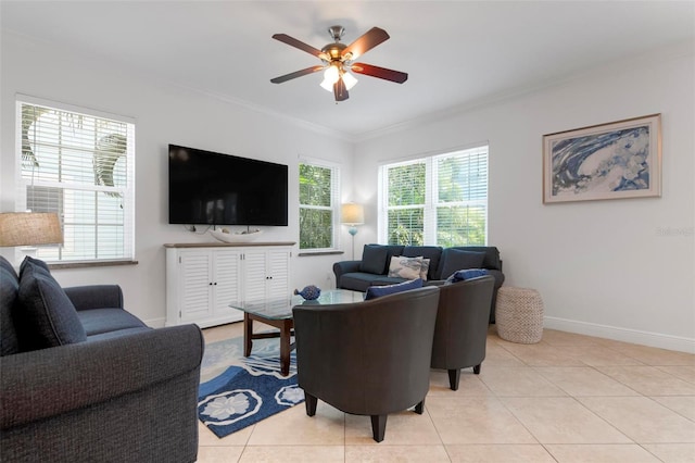 living area with light tile patterned flooring, a ceiling fan, crown molding, and baseboards