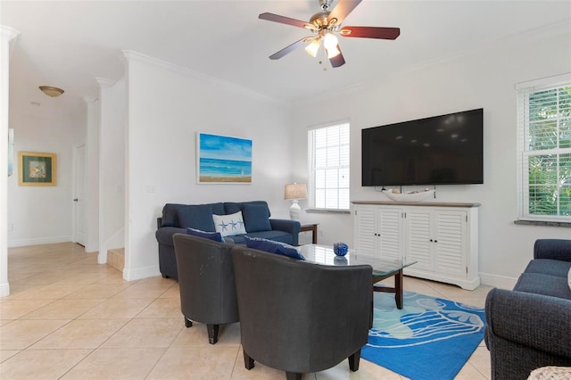 living room featuring light tile patterned floors, ceiling fan, baseboards, and ornamental molding