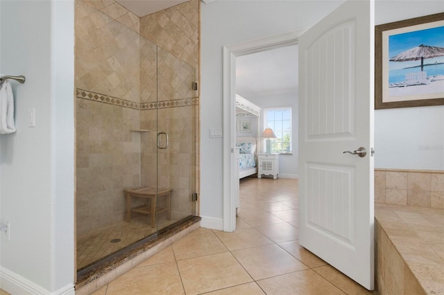 full bath featuring tile patterned flooring, a shower stall, and baseboards