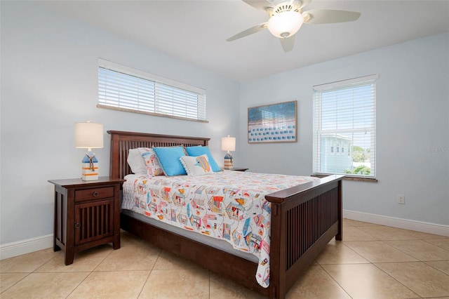 bedroom with light tile patterned floors, baseboards, and ceiling fan