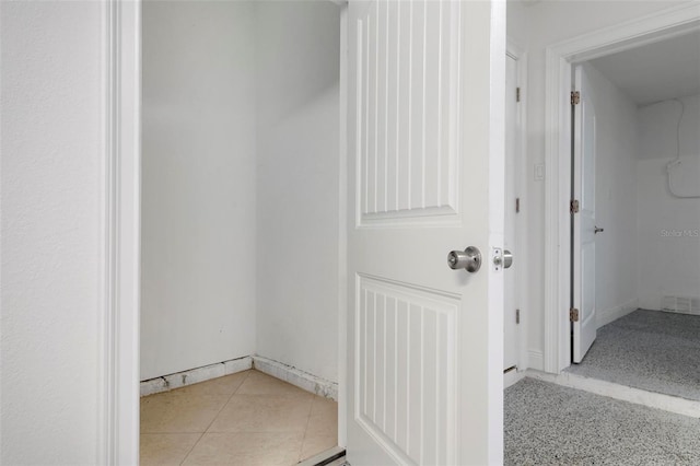 hall featuring tile patterned flooring