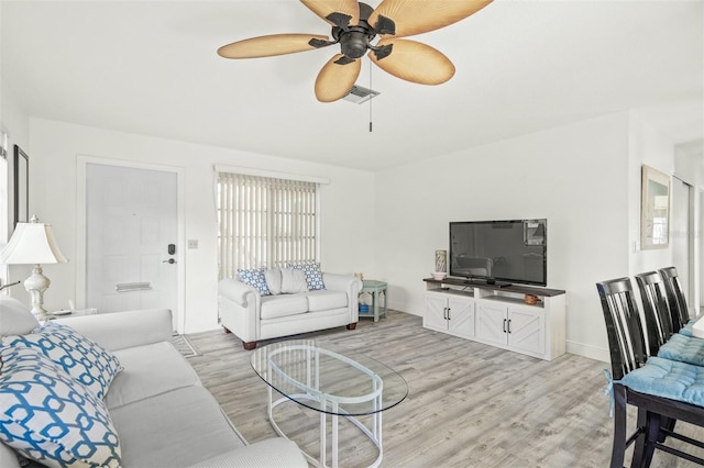 living room with ceiling fan and light hardwood / wood-style floors