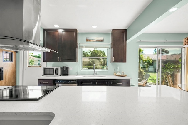 kitchen featuring dishwasher, sink, light stone countertops, black electric cooktop, and island exhaust hood