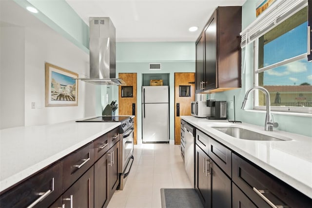 kitchen featuring light tile patterned flooring, sink, dark brown cabinets, island range hood, and stainless steel appliances