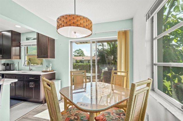 dining room with sink and light hardwood / wood-style flooring