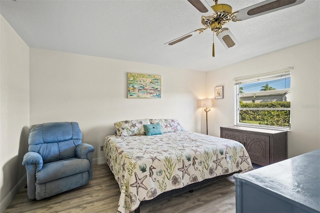 bedroom with a textured ceiling, dark hardwood / wood-style flooring, and ceiling fan