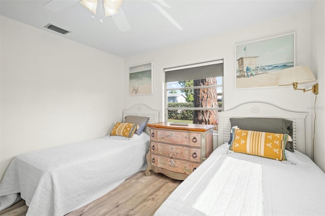 bedroom with ceiling fan and wood-type flooring