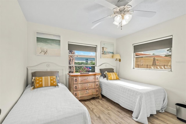 bedroom with ceiling fan and light hardwood / wood-style floors