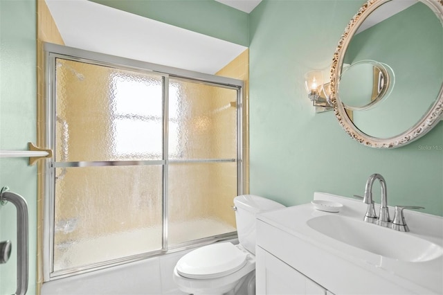 full bathroom featuring shower / bath combination with glass door, vanity, and toilet