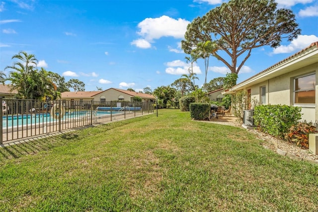 view of yard featuring a fenced in pool and a patio