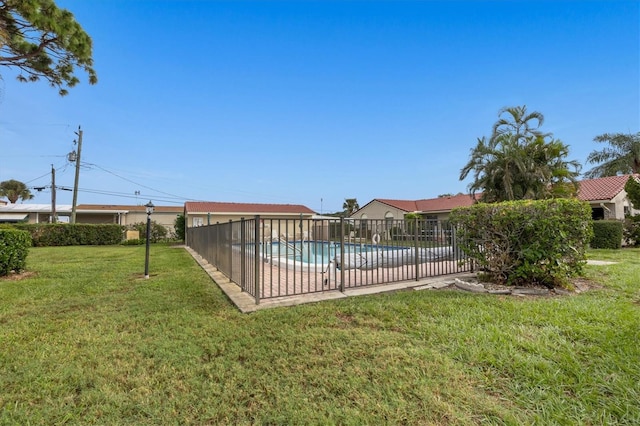 view of swimming pool featuring a lawn