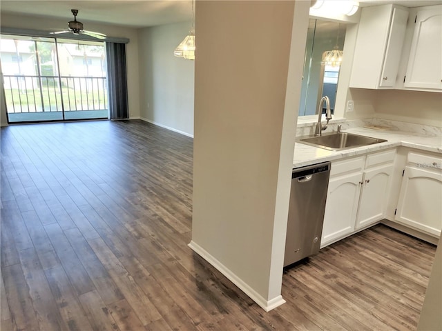 kitchen with dark hardwood / wood-style flooring, white cabinetry, sink, and stainless steel dishwasher