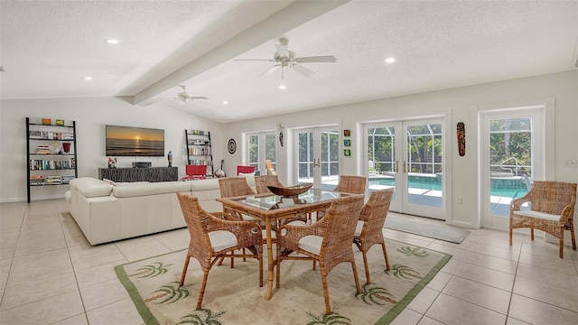 tiled dining space with french doors, vaulted ceiling with beams, a textured ceiling, and a wealth of natural light