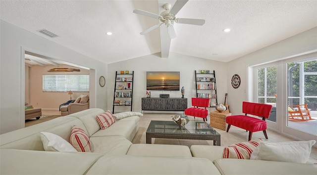 living room featuring lofted ceiling with beams, ceiling fan, a textured ceiling, and a wealth of natural light