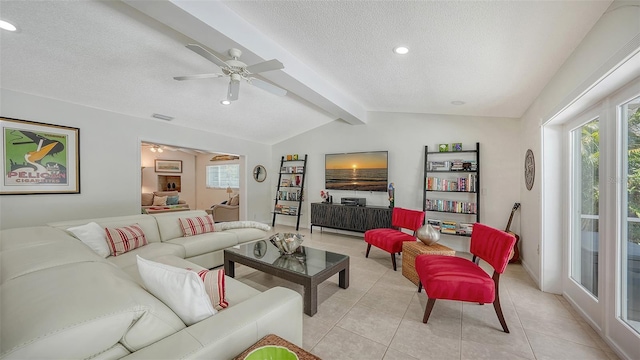 tiled living room with a textured ceiling, lofted ceiling with beams, and ceiling fan