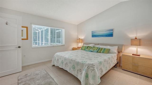 tiled bedroom with vaulted ceiling